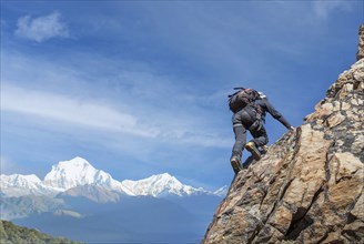 Man climbing rocky wall of Mont Blanc