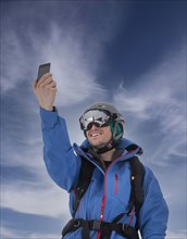 Skier taking selfie in mountains