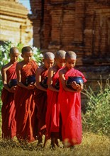 Buddhist monks holding bowls during morning alms