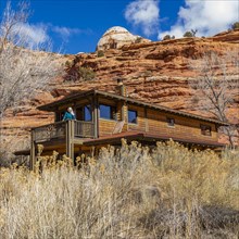 Woman on deck of home in canyon in Grand Staircase-Escalante National Monument