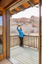 Woman on deck of home in canyon in Grand Staircase-Escalante National Monument