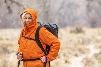 Woman hiking during snow flurry in Grand Staircase-Escalante National Monument