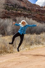 Woman jumping for joy in Grand Staircase-Escalante National Monument