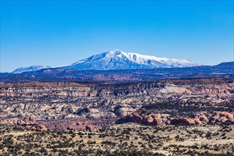 Distant snowy mountains in rocky landscape of Grand Staircase-Escalante National Monument