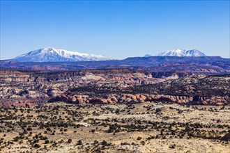 Distant snowy mountains in rocky landscape of Grand Staircase-Escalante National Monument
