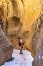 Woman hiking in slot canyon in Grand Staircase-Escalante National Monument