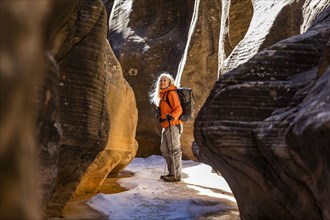 Woman hiking in slot canyon in Grand Staircase-Escalante National Monument