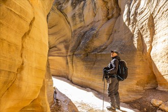 Man hiking in slot canyon in Grand Staircase-Escalante National Monument
