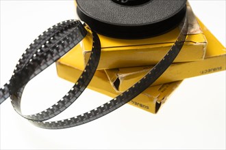 Studio shot of 8 mm film reel spool and boxes