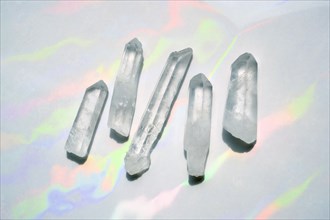 Transparent quartz crystals with rainbow light background