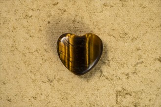 Wooden heart on beige background