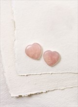 Glass hearts on white paper