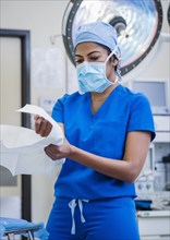 Female doctor preparing for surgery in operating theater