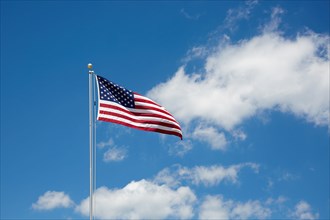 American flag against cloudy sky