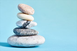 Stack of stones on blue background