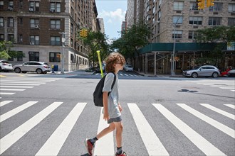 USA, New York, New York City, Boy crossing street