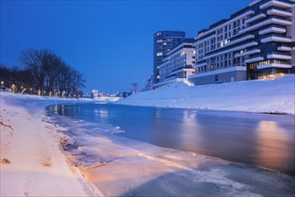 Poland, Subcarpathia, Rzeszow, Residential buildings at riverbank in winter