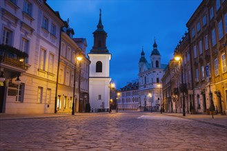 Poland, Masovia, Warsaw, Cobblestone street in old town at night