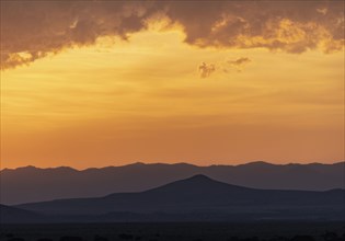 Usa, New Mexico, Santa Fe, El Dorado, Sunset sky with clouds over desert landscape