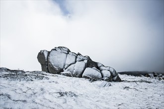 Australia, New South Wales, Snowcapped rock in mountains at Charlotte Pass in Kosciuszko National Park