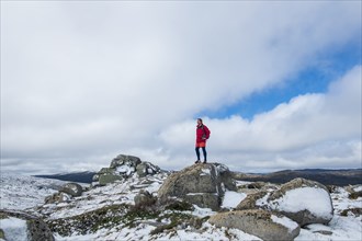 Australia, New South Wales, Man standing on rock at Charlotte Pass in Kosciuszko National Park