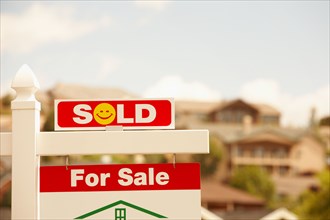 Sold sign in front of house