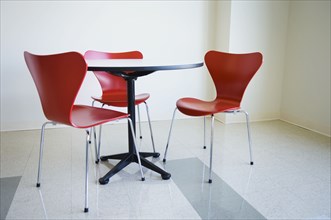 Empty table and red chair in cafeteria