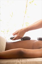 Back of woman receiving hot stone massage