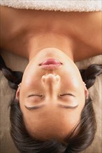Close-up of woman with eyes closed on massage table