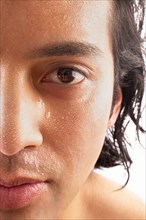 Close-up of man with water drops on face