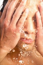 Close-up of man washing face