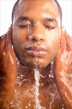 Close-up of man washing face