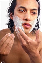 Close-up of man applying shaving cream