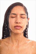 Studio shot of woman with water on face