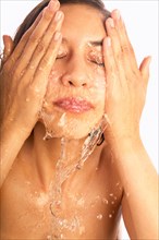 Close-up of woman washing face