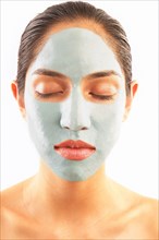 Studio shot of woman with blue facial mask