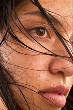 Close-up of woman with wet brown hair