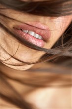Close-up of woman's lips and brown hair