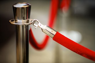 Close-up of red rope and stanchion