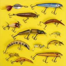Retro fishing lures against yellow background