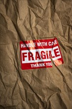 Fragile handle with care sticker on crushed package