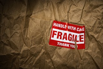 Fragile handle with care sticker on crushed package