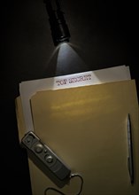 Overhead view of top secret documents on desk top
