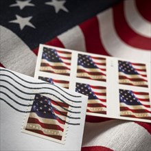 Close-up of flag postage stamps and American flag