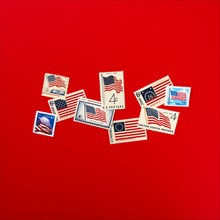 Retro postage stamps against red background