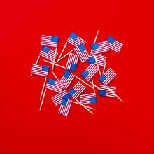 Small American flag toothpicks on red background