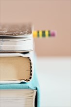 Close-up of stack of books with pencil