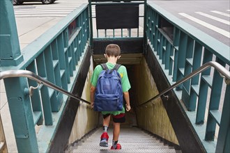 Rear view of boy with backpack