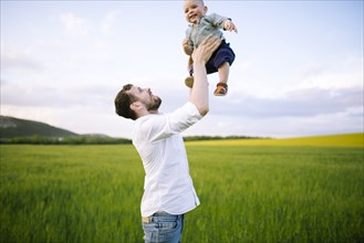 Father playing with baby son