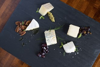 Cheese and herbs on cutting board